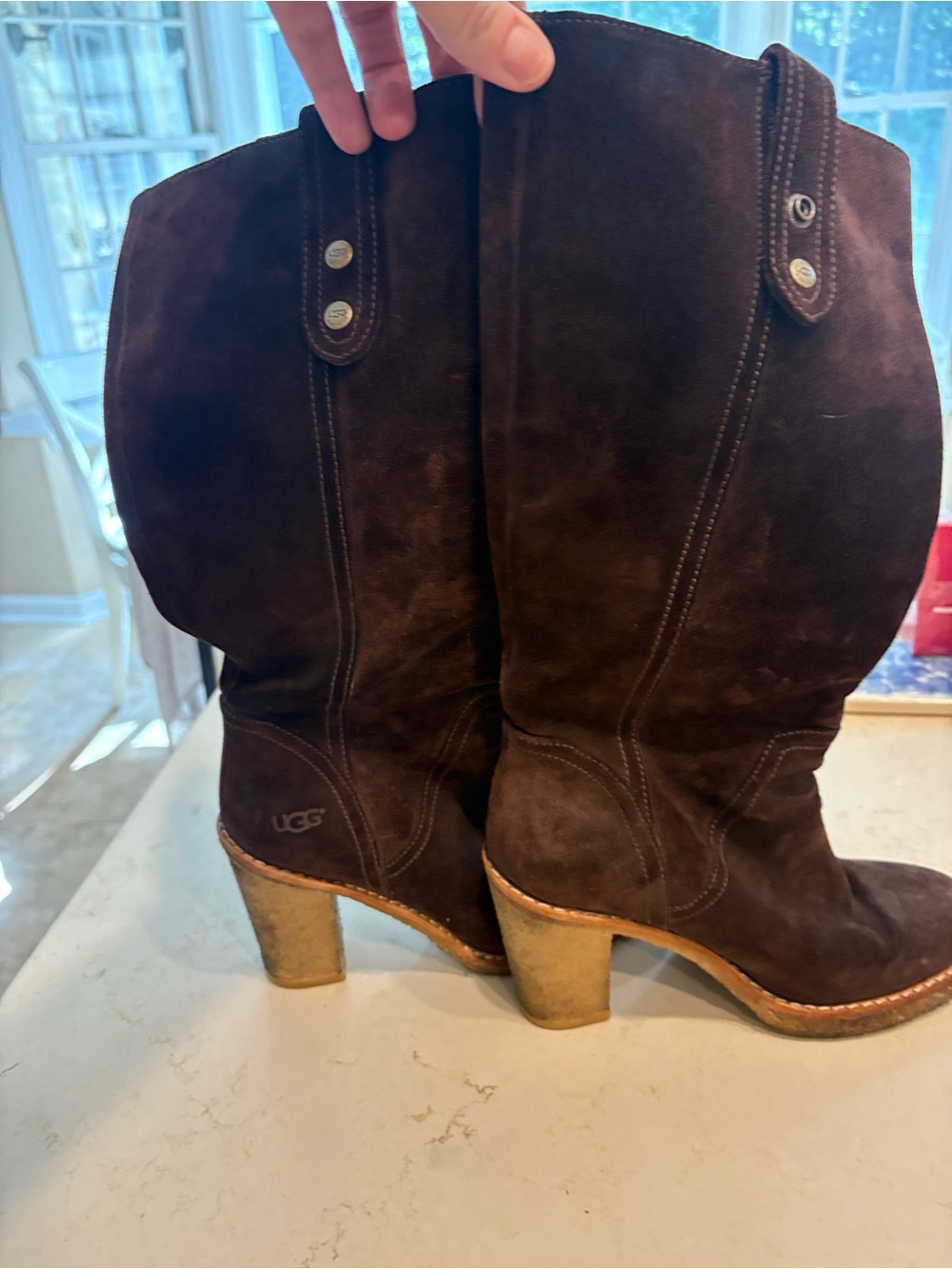 Chocolate brown UGG suede boots with rubber sole and heel